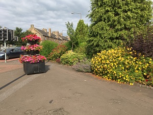 Mill Road crossroads corner bed and flower tower